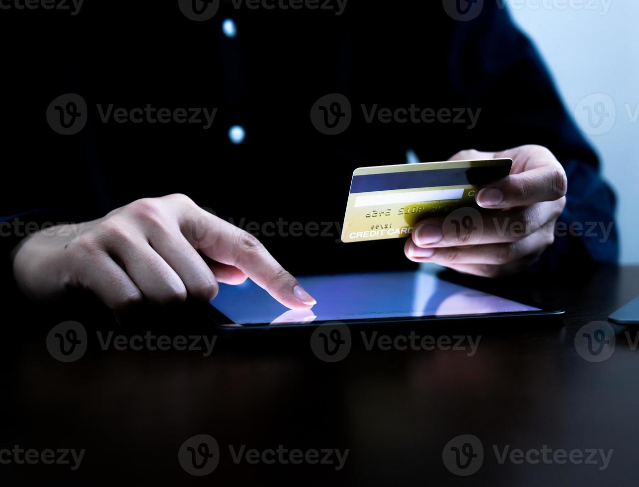 Closeup hand woman using tablet or laptop shopping online,e-business concept. photo