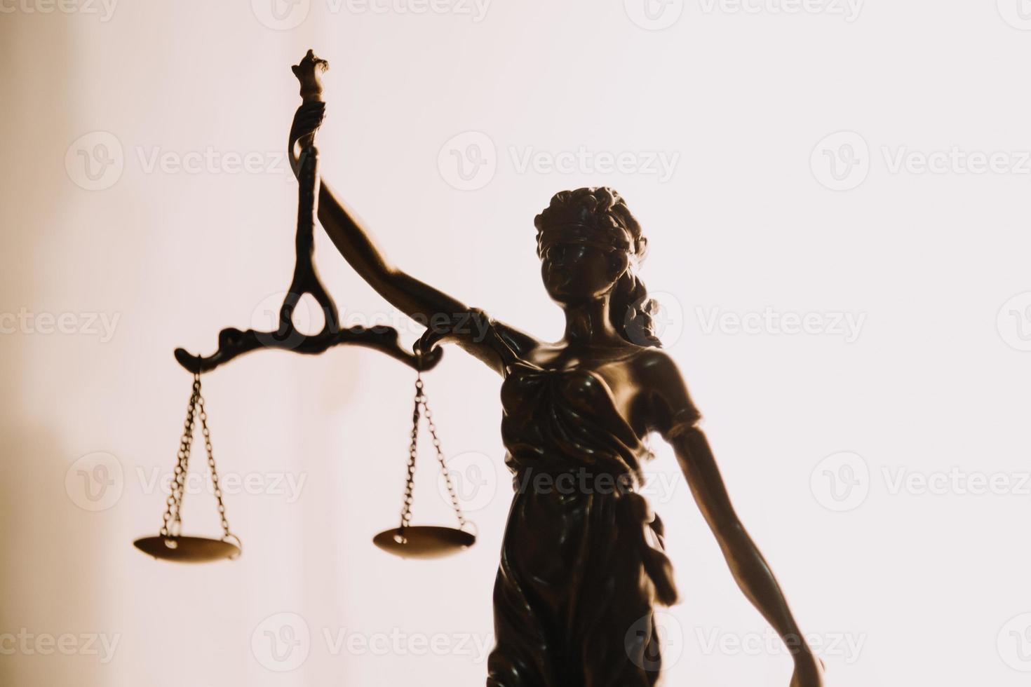 Justice and law concept.Male judge in a courtroom with the gavel, working with, computer and docking keyboard, eyeglasses, on table in morning light photo