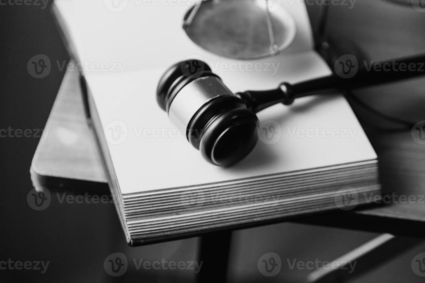 Justice and law concept.Male judge in a courtroom with the gavel, working with, computer and docking keyboard, eyeglasses, on table in morning light photo