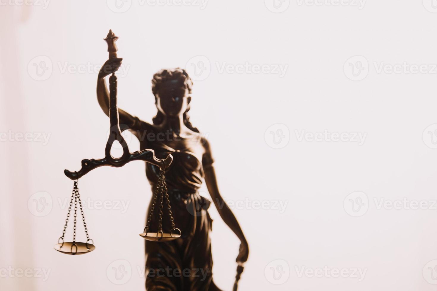 Justice and law concept.Male judge in a courtroom with the gavel, working with, computer and docking keyboard, eyeglasses, on table in morning light photo