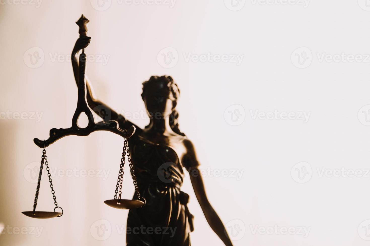 Justice and law concept.Male judge in a courtroom with the gavel, working with, computer and docking keyboard, eyeglasses, on table in morning light photo