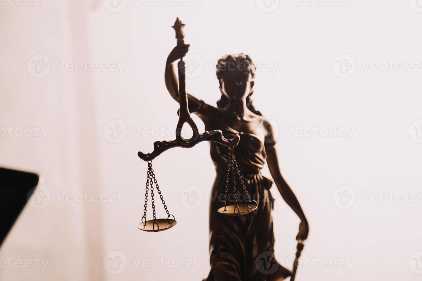 Justice and law concept.Male judge in a courtroom with the gavel, working with, computer and docking keyboard, eyeglasses, on table in morning light photo