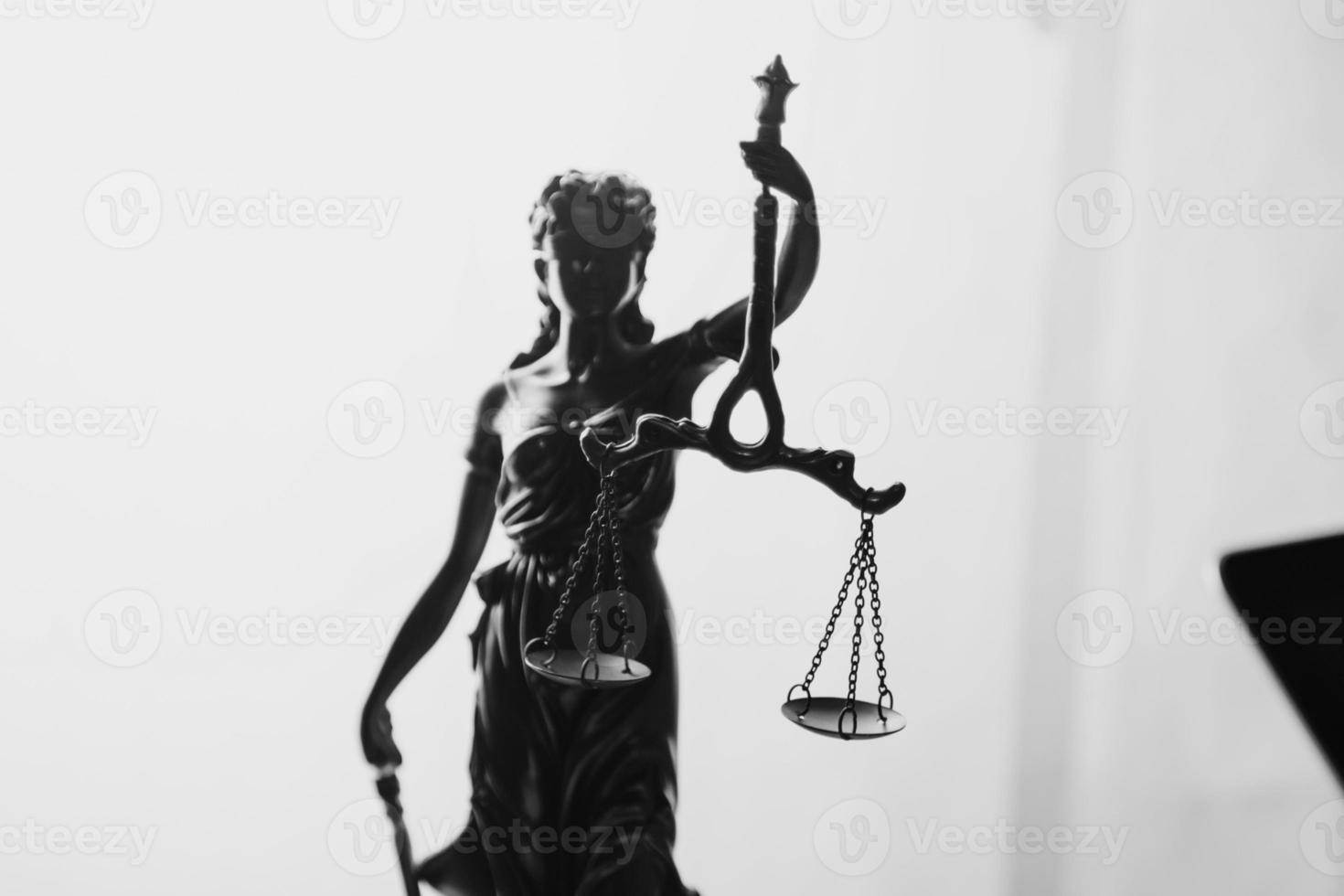 Justice and law concept.Male judge in a courtroom with the gavel, working with, computer and docking keyboard, eyeglasses, on table in morning light photo