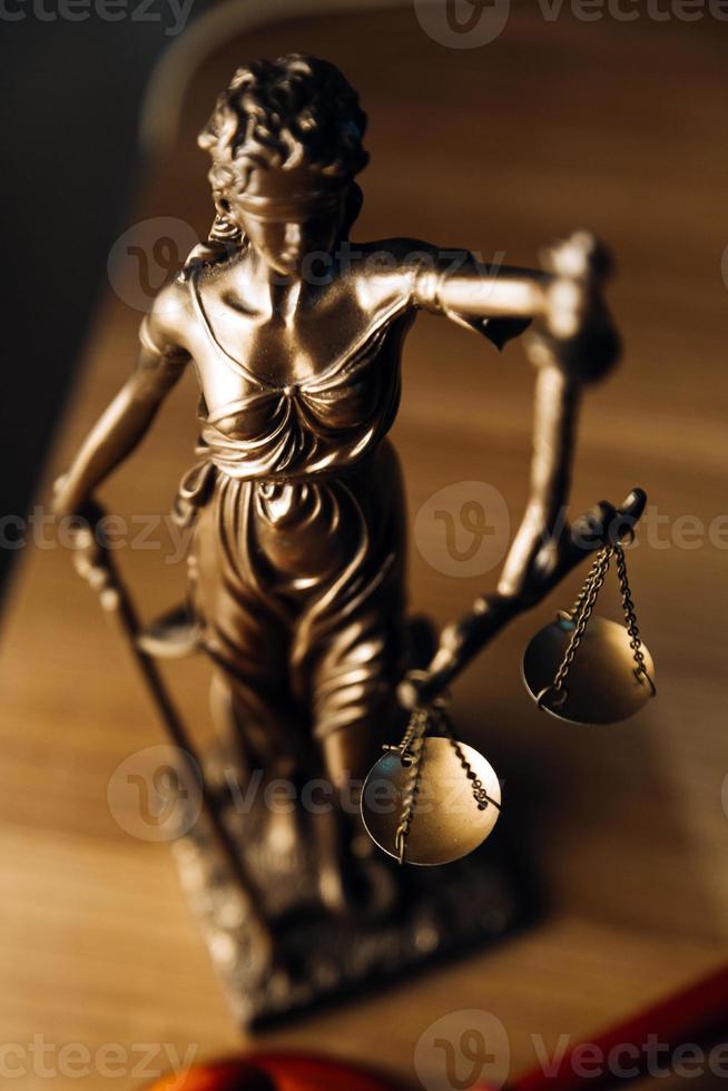 Justice and law concept.Male judge in a courtroom with the gavel, working with, computer and docking keyboard, eyeglasses, on table in morning light photo