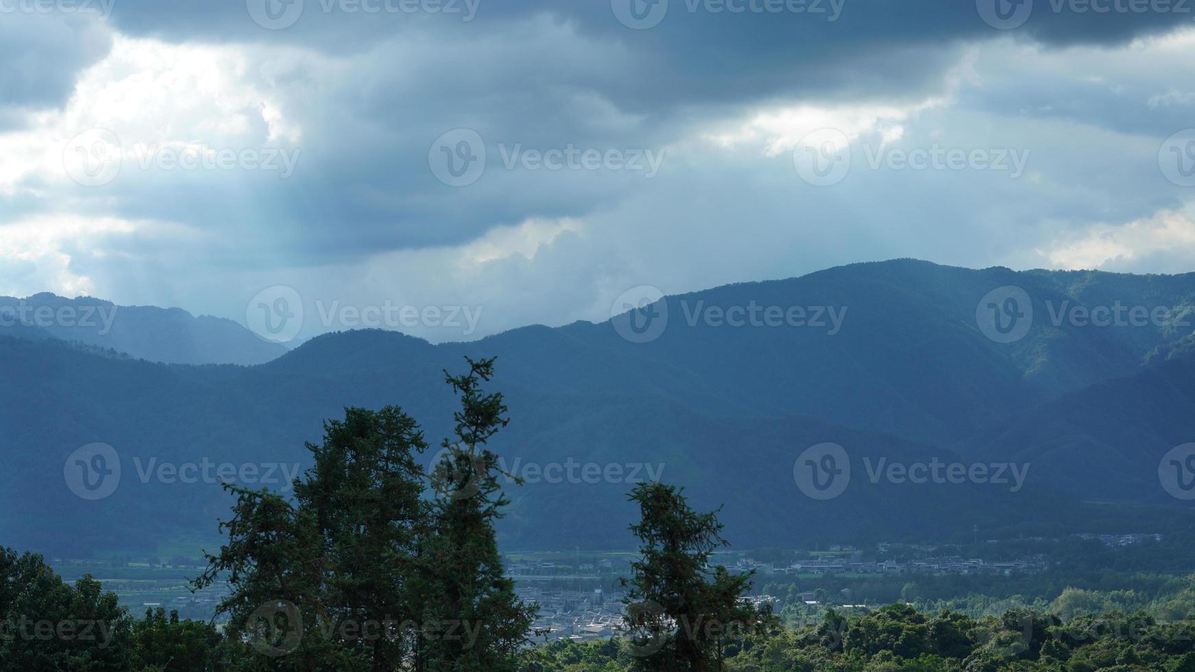 The beautiful mountains view with the cloudy sky and valley among them photo
