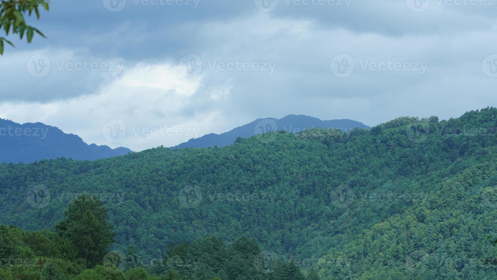 The beautiful mountains view with the cloudy sky and valley among them photo