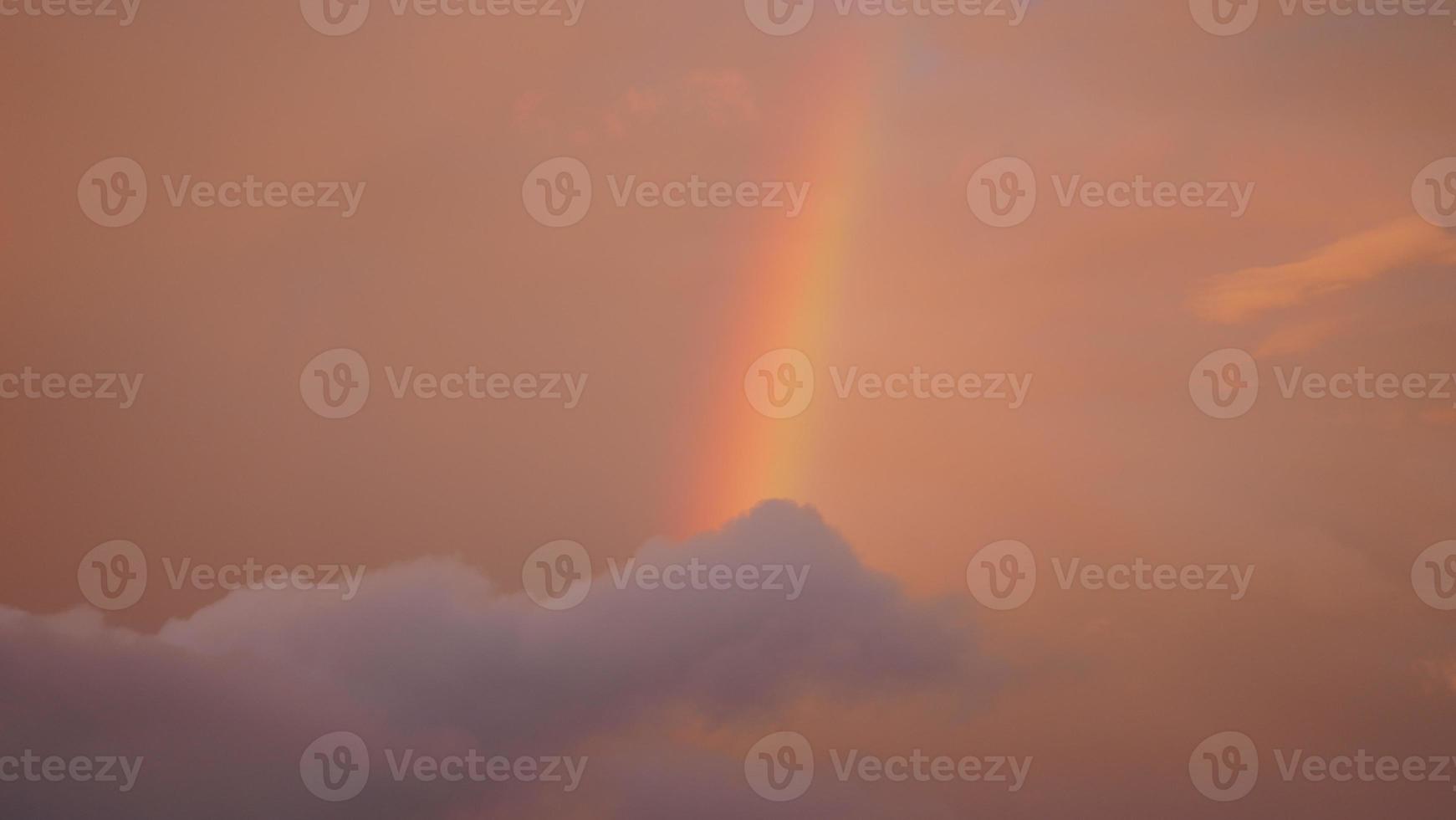 The colorful rainbow rising up in the sky after the summer rainning photo