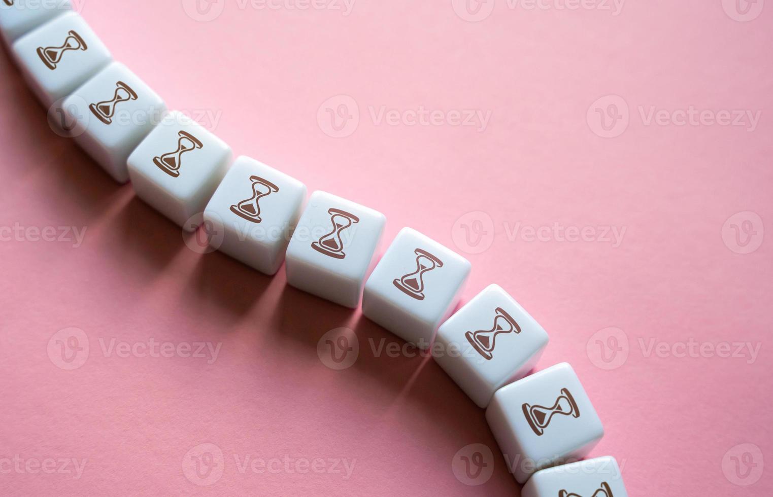 Time chain. Time flow. Process duration. The concept of waiting and reporting events. Hourglasses in a long curved line of blocks. Days, months. periods and deadlines. photo