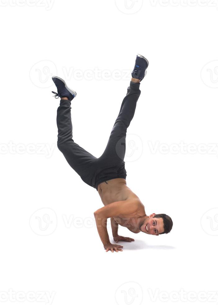 Cool young break dancer performing in studio on white background. photo