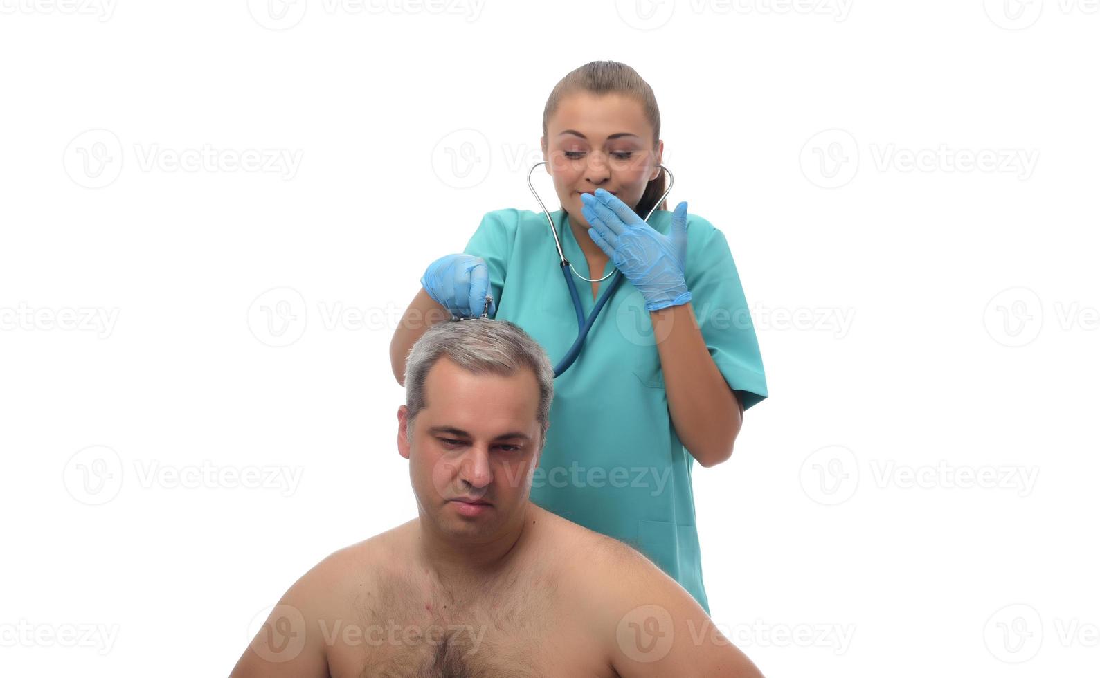 Female Doctor checking on patient with stethoscope. photo