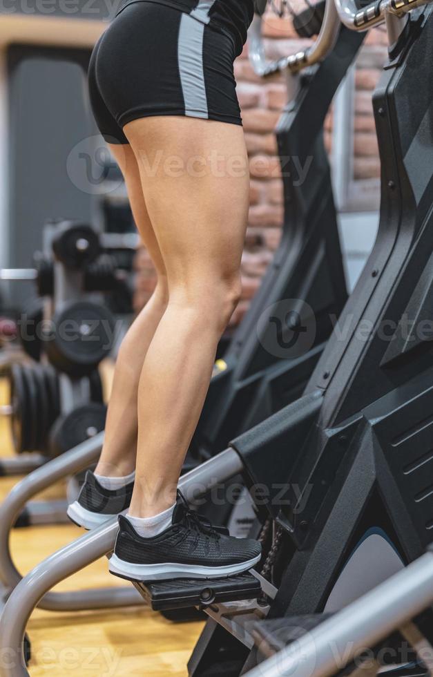 Young woman workout on treadmill in gym. Healthy lifestyle. Selective focus. Motion Blur. photo