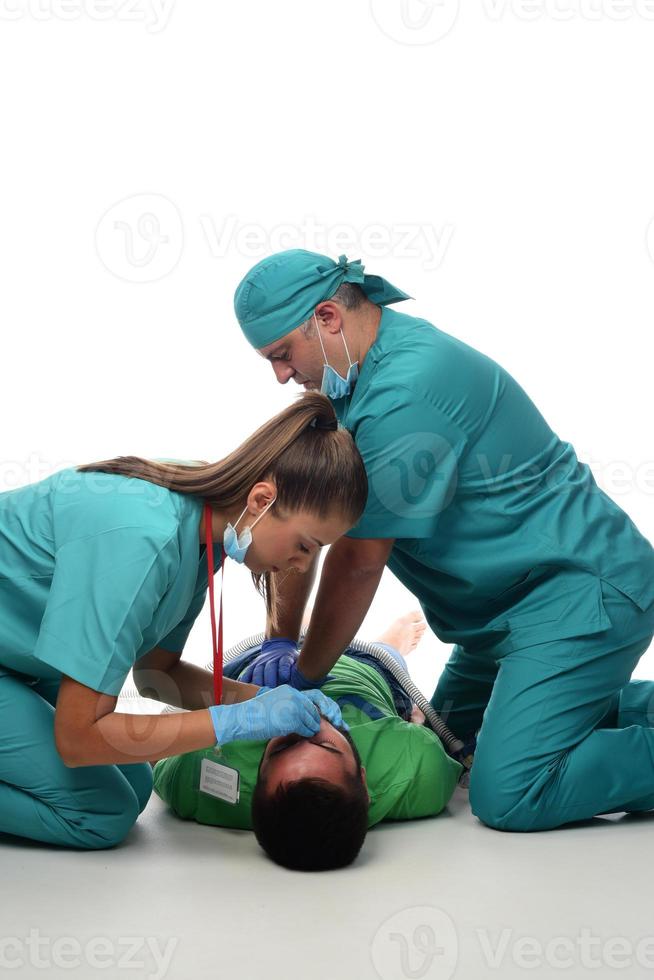 Female doctor with medical team giving cpr to patient. photo