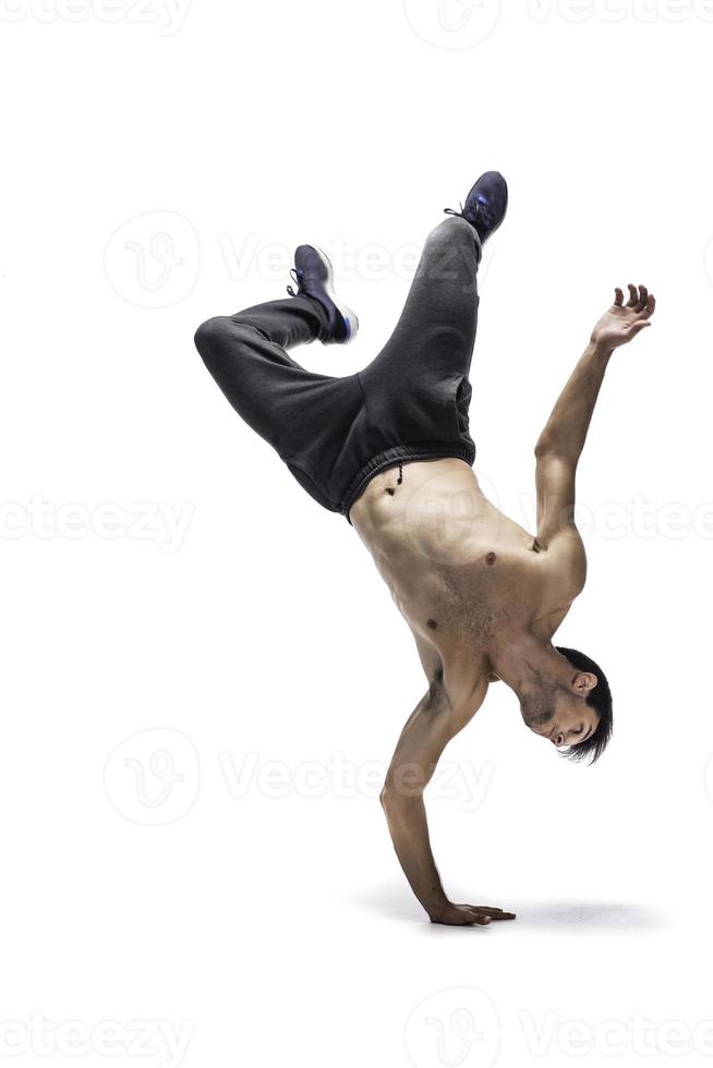 Cool young break dancer performing in studio on white background. photo