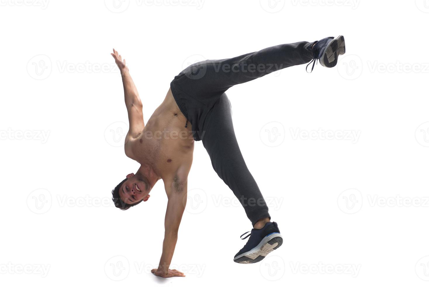 Cool young break dancer performing in studio on white background. photo