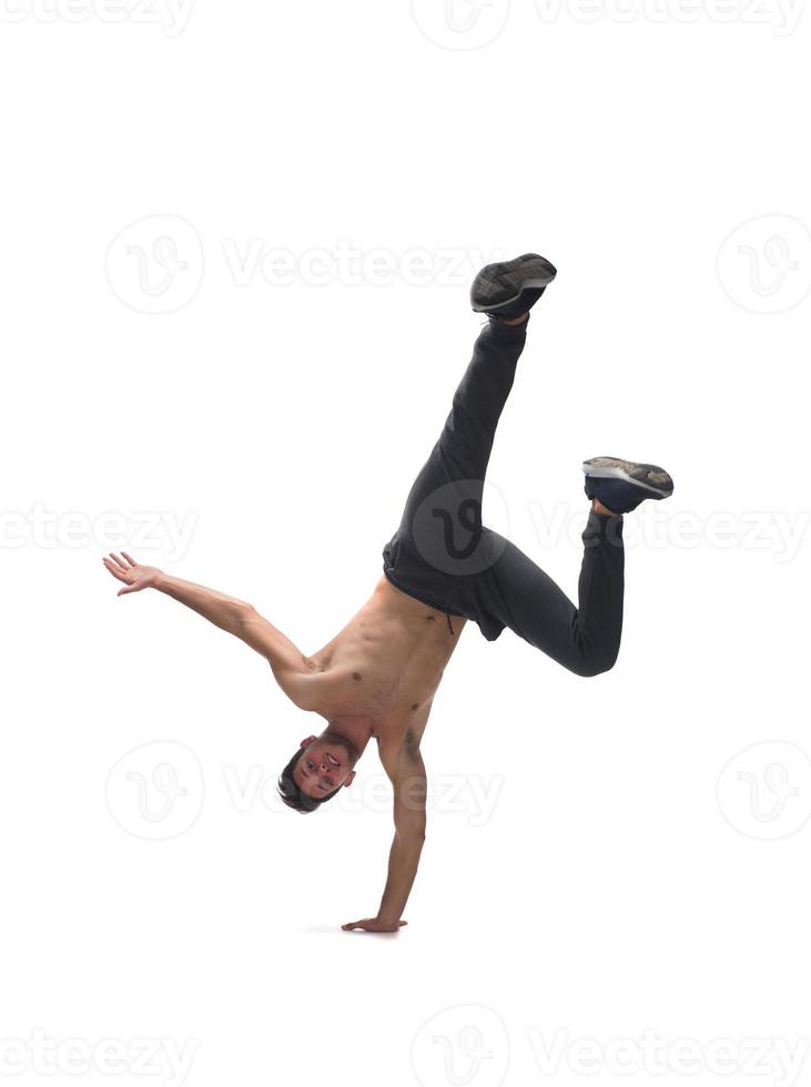 Cool young break dancer performing in studio on white background. photo