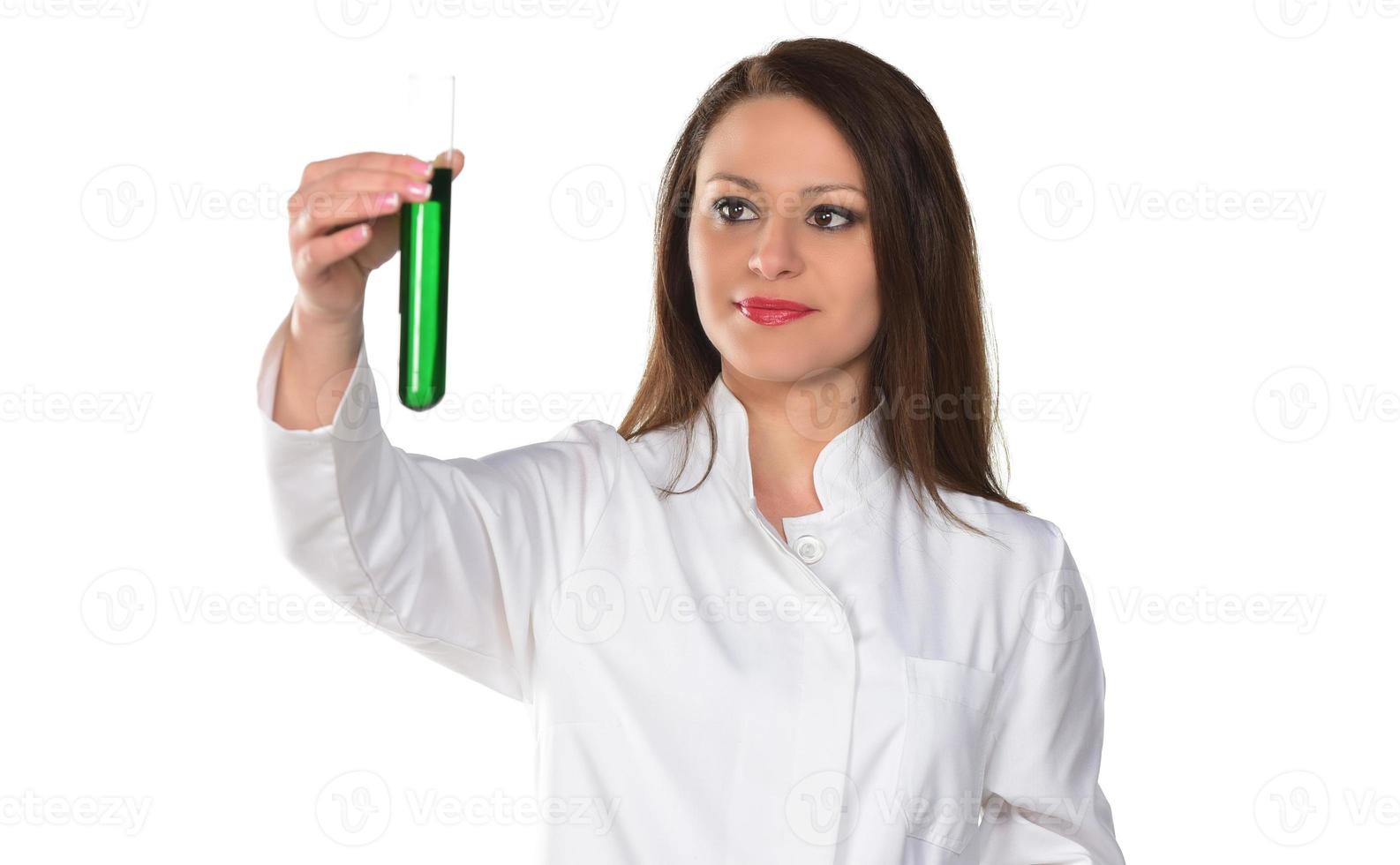 Scientist holding tube with green liquid. Isolated on white background. photo