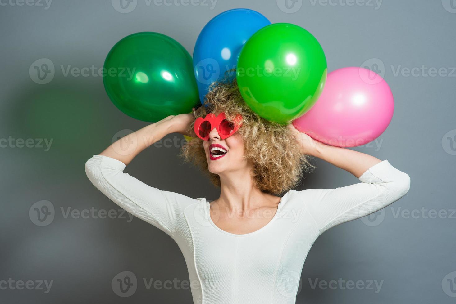 funny blonde women holding balloons celebrating new year photo