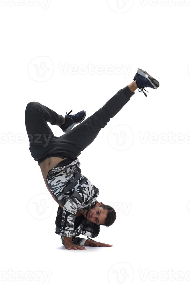 Cool young break dancer performing in studio on white background. photo