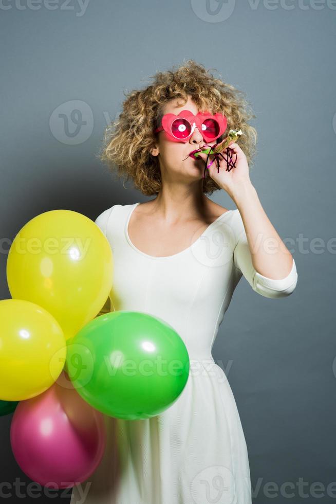 funny blonde women holding balloons celebrating new year photo