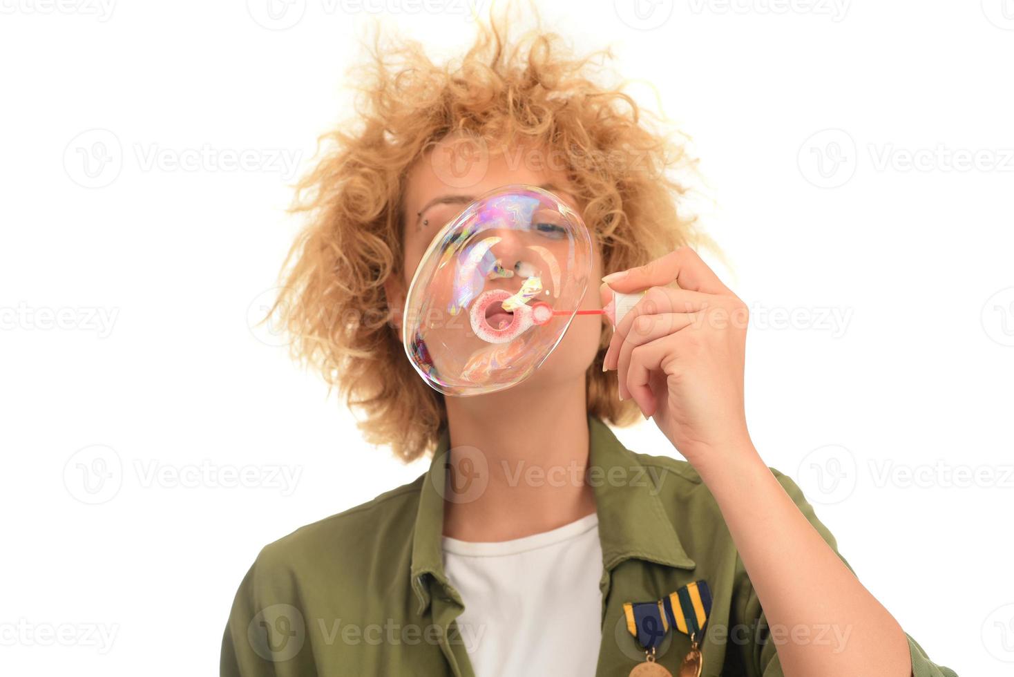 f young female model blowing soap bubbles photo