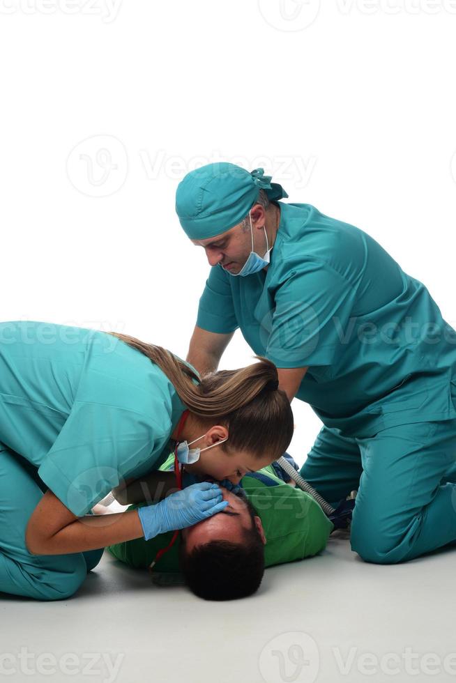 Female doctor with medical team giving cpr to patient. photo