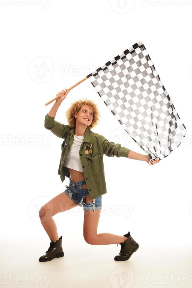 beautiful model holding finish flag isolated on white background. motorsport finish flag in hands of a female model. photo