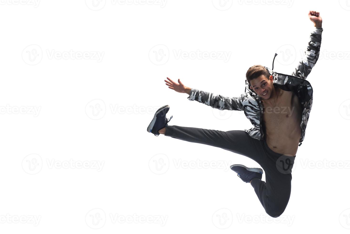 Cool young break dancer performing in studio on white background. photo