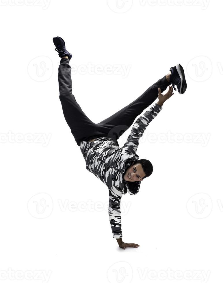 Cool young break dancer performing in studio on white background. photo