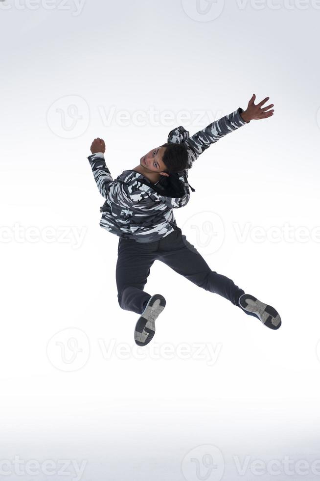 Cool young break dancer performing in studio on white background. photo