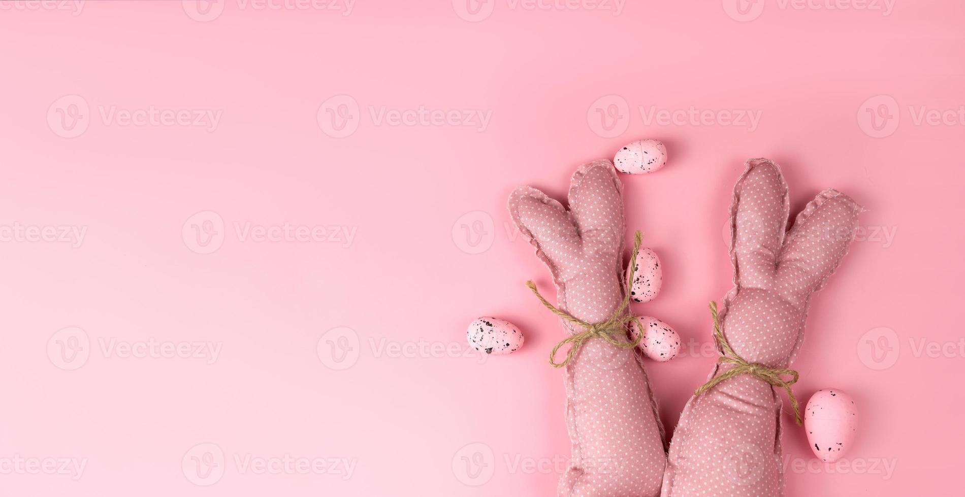 Pink toy bunnies on pink background .Flat lay banner with place for text photo