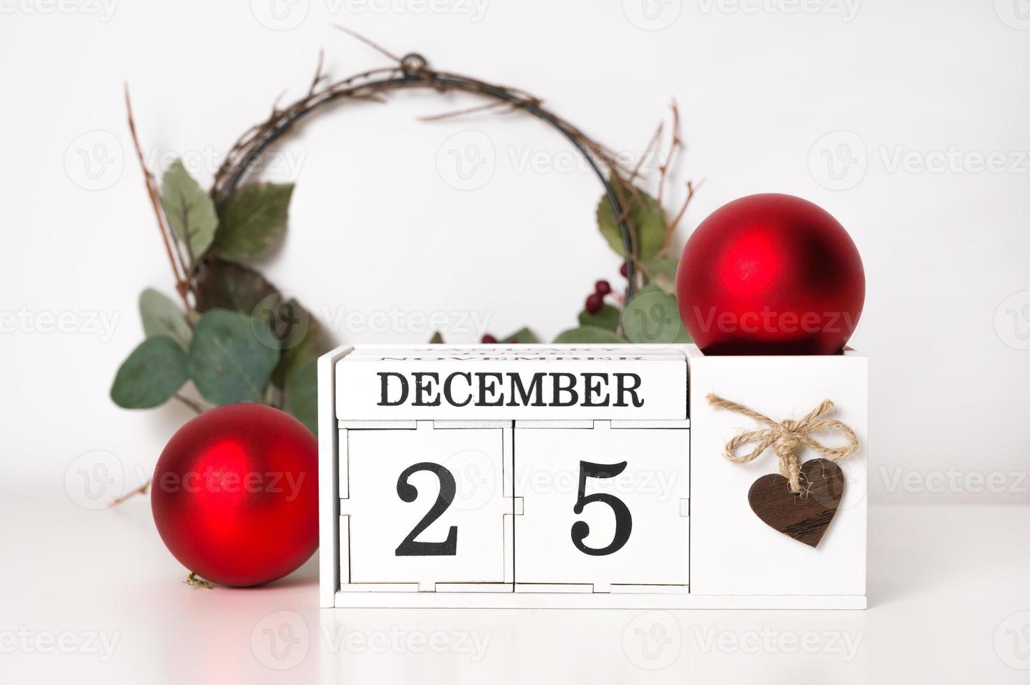 Christmas background with wreath,wooden block calendar and ornaments. December 25th . photo