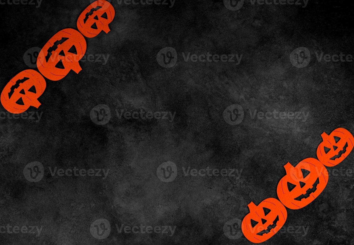 Top view on felted pumpkins on dark concrete background with place for text. Halloween concept photo