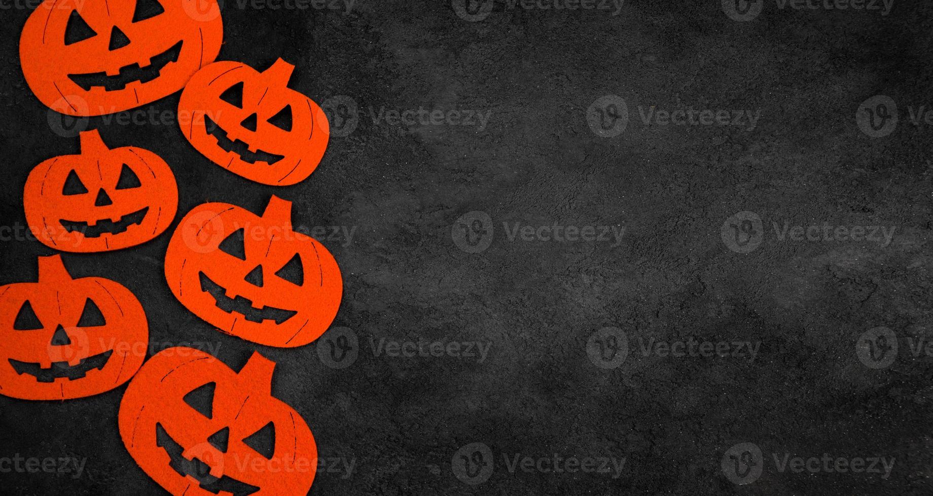 Minimalistic halloween flat lay with pumpkins on black concrete background.Copyspace banner photo