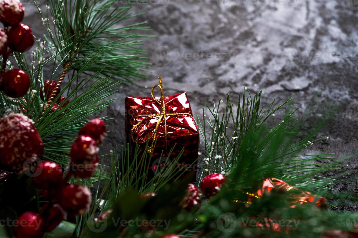 fir tree branches and gift boxes on dark background. Banner with place for text.Christmas background photo