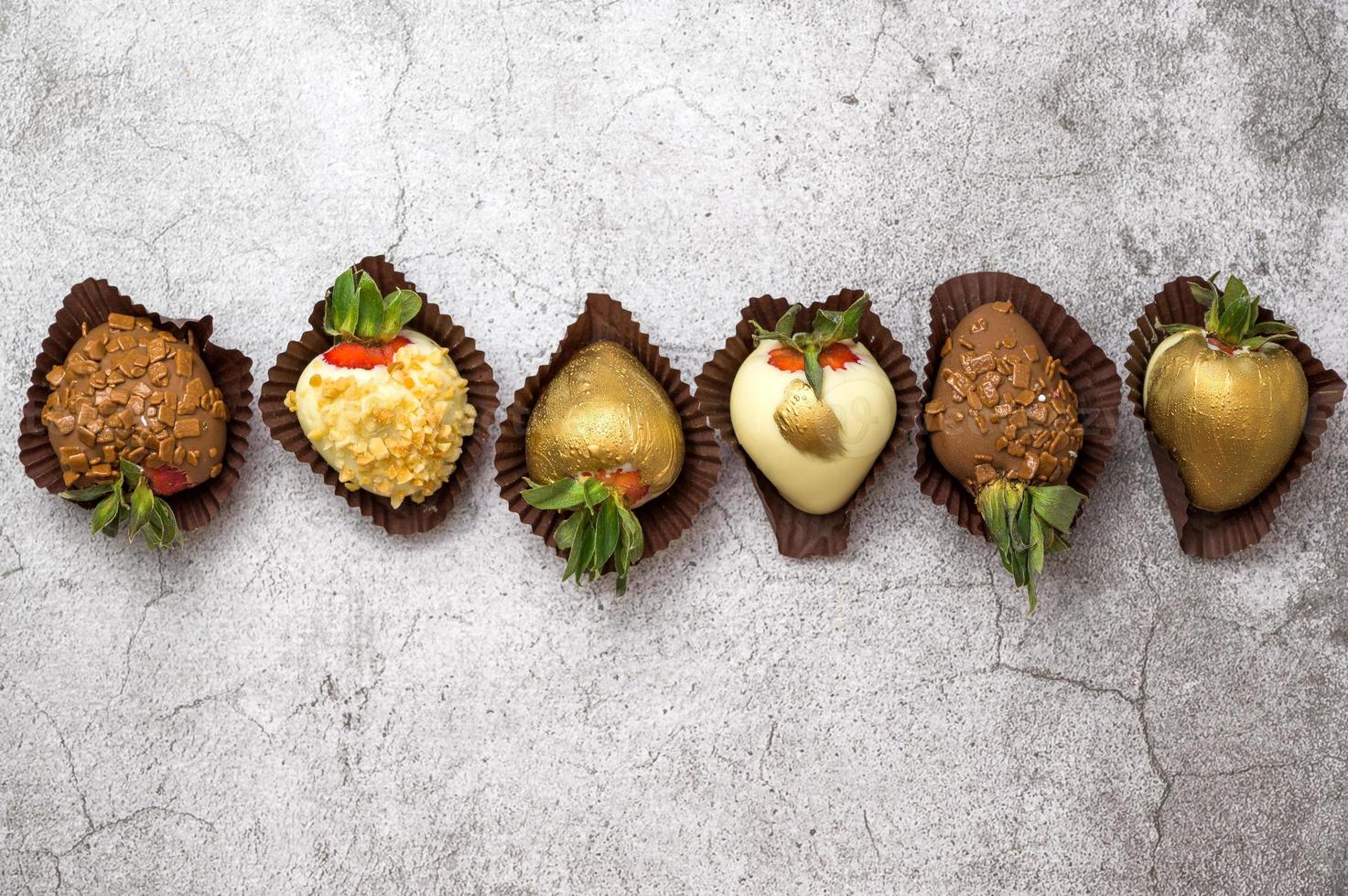 Flat lay with assorted chocolate covered strawberries. Dessert concept photo