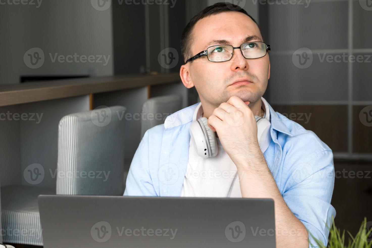 Puzzled asian man using laptop for work,education,programming etc. photo