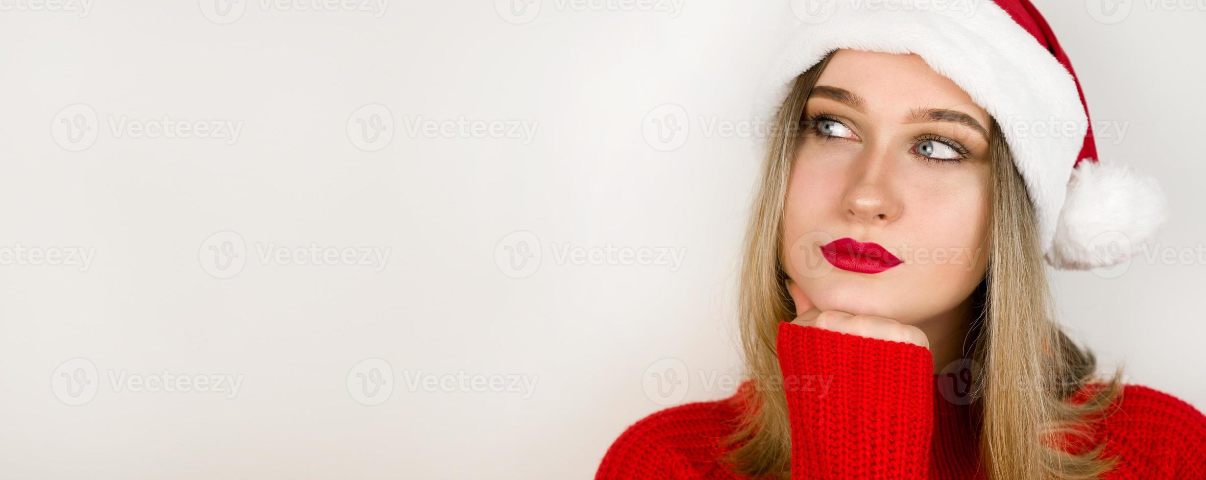 Close up portrait of santa woman looking at copyspace having thoughts about future events. Winter holidays and christmas concept photo