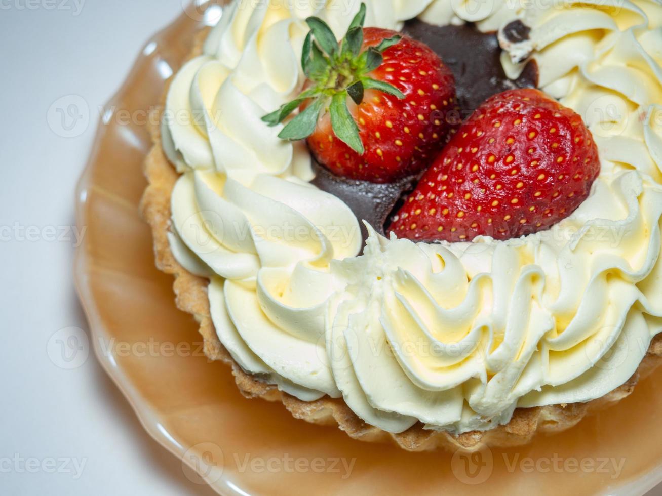 Cake with butter cream and strawberrie on the plates. Sweetness on a white background. Treat for tea.  bitten cake photo