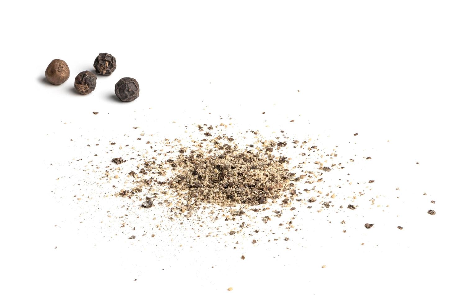 Ground black pepper and ground black pepper on white background photo