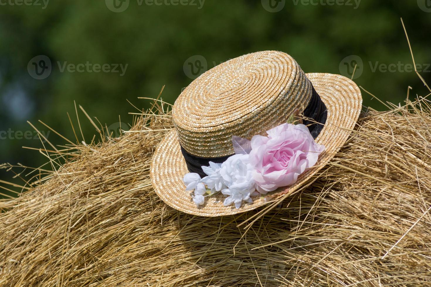 Close-up view of straw hat on hay bale in Provence photo