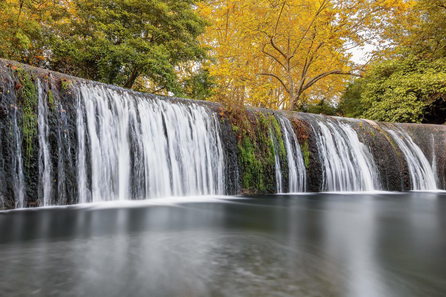 Scenic view of waterfall in forest in south of France during autumn photo