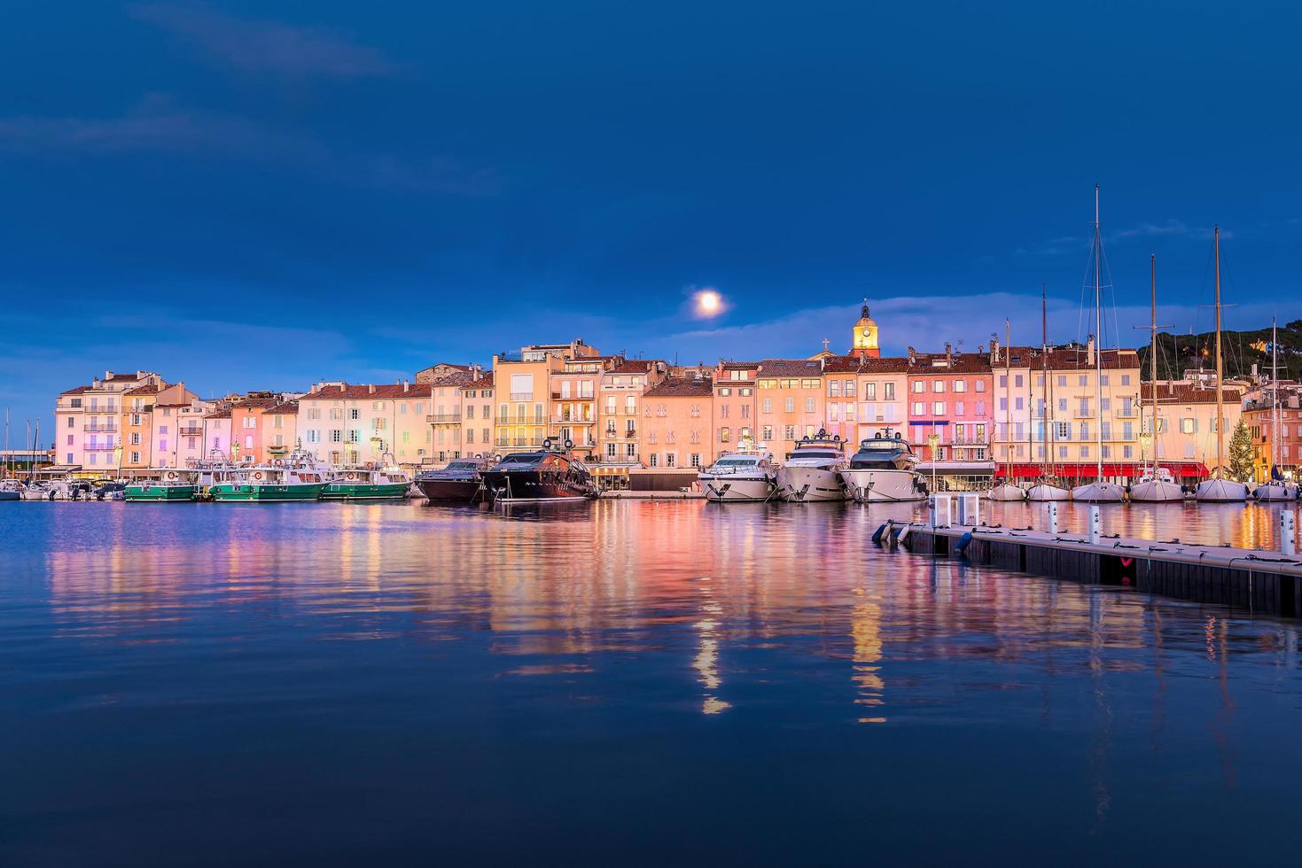 Scenic view of Christmas colorful illuminated Saint-Tropez against full moon photo