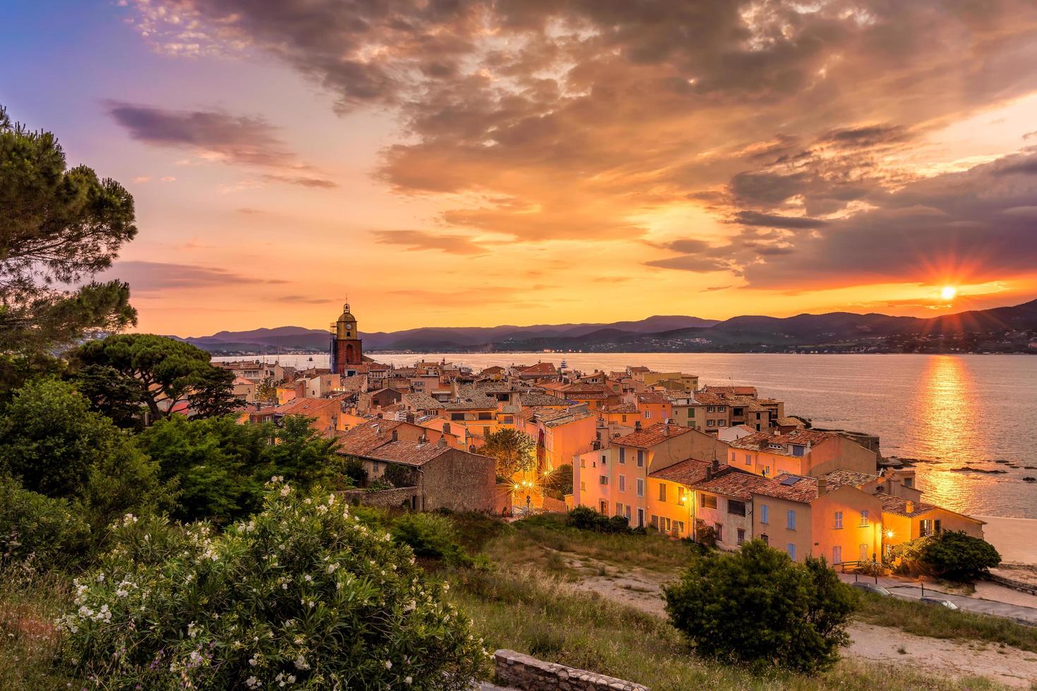 Scenic view of Saint Tropez in summer sunset light and city lights turned on photo