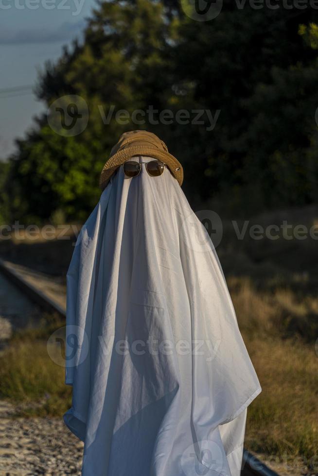 White ghost with black eyes, made from a bedsheet. whit hat photo