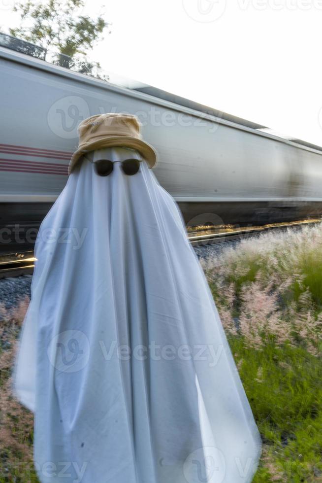 ghost on train tracks with train passing behind, at sunset, mexico latin america photo