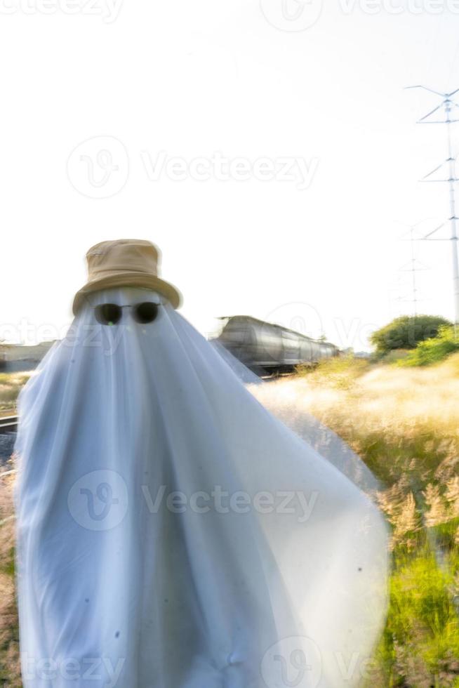 ghost standing around vegetation in broad daylight, at sunset, mexico photo