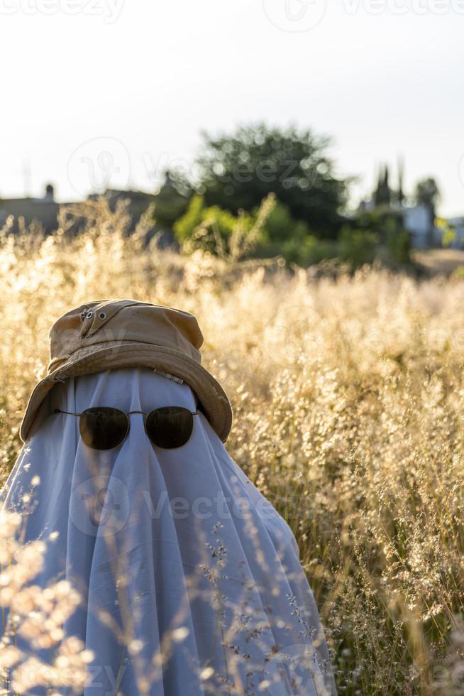 ghost standing around vegetation in broad daylight, at sunset, mexico photo