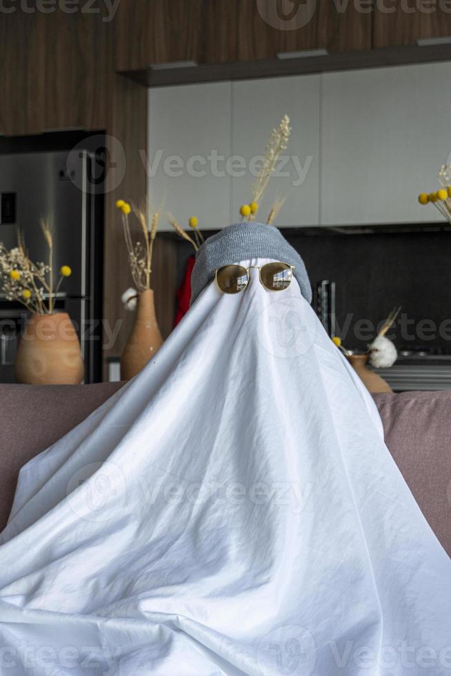 White ghost with black eyes, made from a bedsheet. whit hat photo