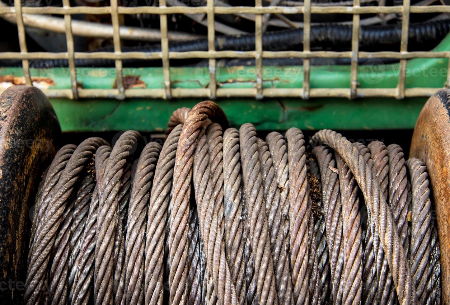 Old sling cable of electric winch in front of 4wd car photo