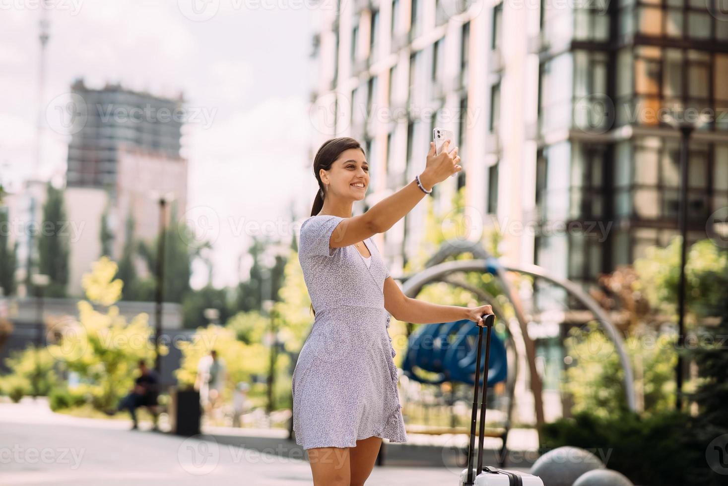 Young woman taking selfies on a phone. photo